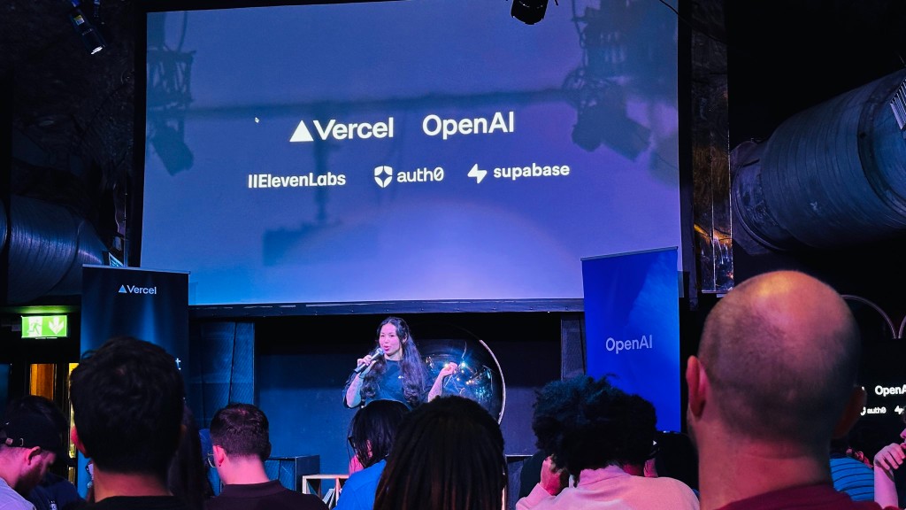 Maya speaking at Built in London in front of a screen with Vercel, OpenAI, ElevenLabs, Auth0 and Supabase logos